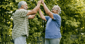 Elderly couple enjoying the benefits of exercise and playing with each other outside.