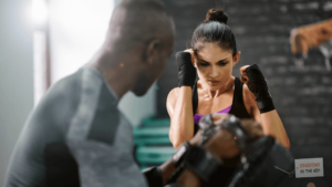 Man training a lady consistency in boxing so she can get healthier